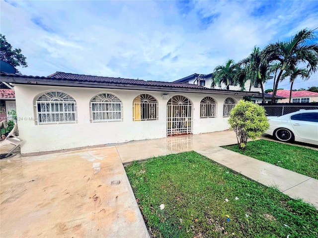 mediterranean / spanish house with a front yard