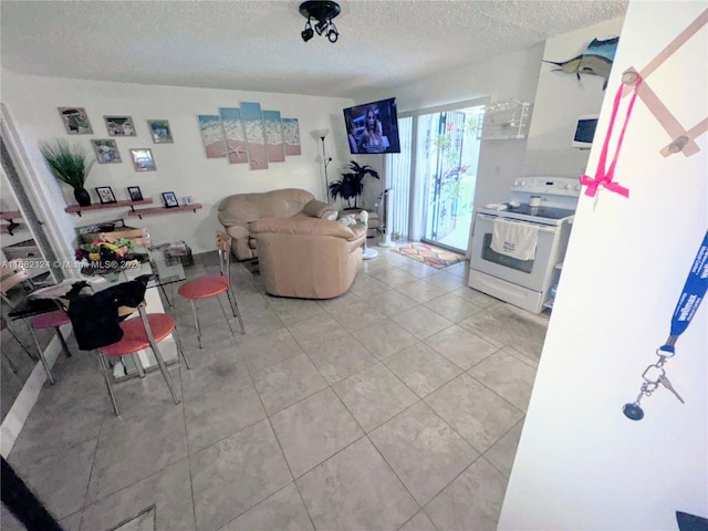 living room with a textured ceiling and light tile patterned floors