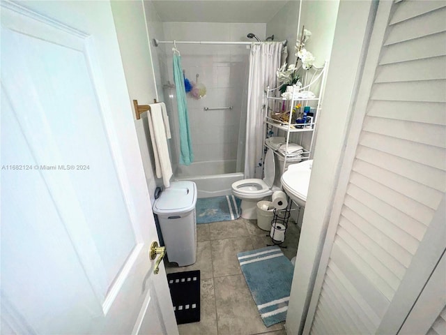 full bathroom featuring toilet, tile patterned floors, sink, and shower / bath combo