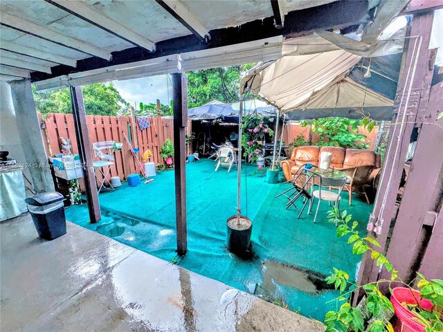 62 NW 73rd Pl, Miami, FL 33126 - fenced backyard with a patio area