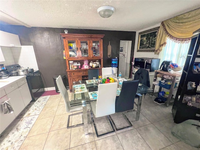 62 NW 73rd Pl, Miami, FL 33126 - dining room with light tile patterned floors and a textured ceiling