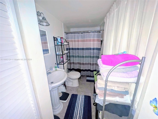 bathroom featuring tile patterned floors, sink, and toilet