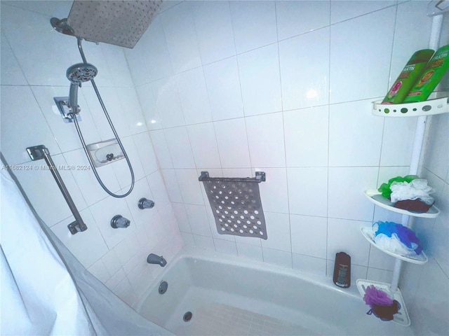 bathroom with shower / bath combination with curtain