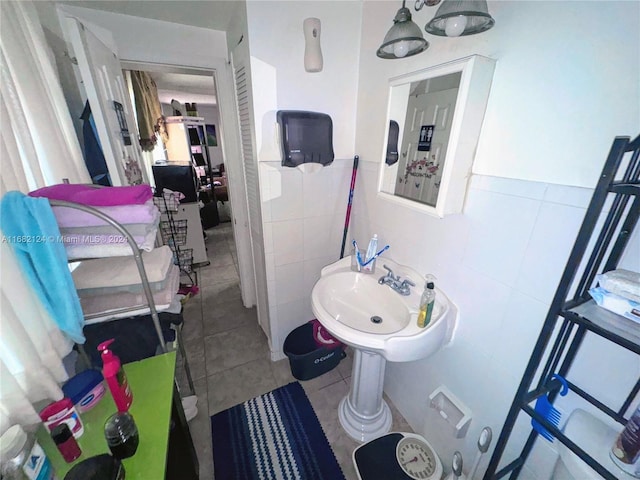 62 NW 73rd Pl, Miami, FL 33126 - bathroom with tile walls, tile patterned floors, and wainscoting