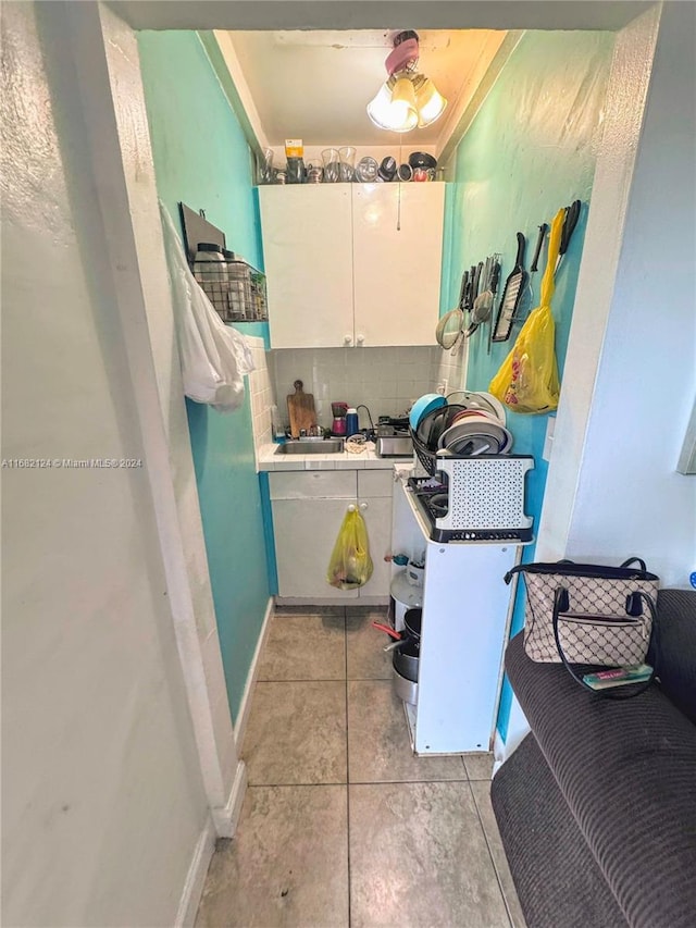 bathroom with ornamental molding, decorative backsplash, and tile patterned floors