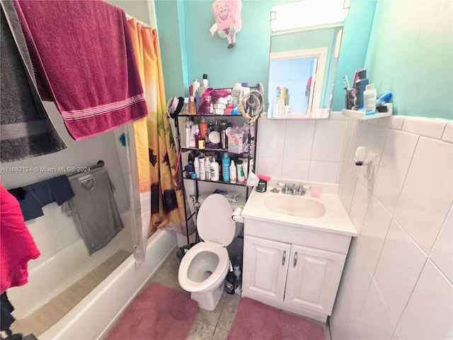 full bathroom with shower / bath combination with curtain, toilet, tile patterned floors, tile walls, and vanity