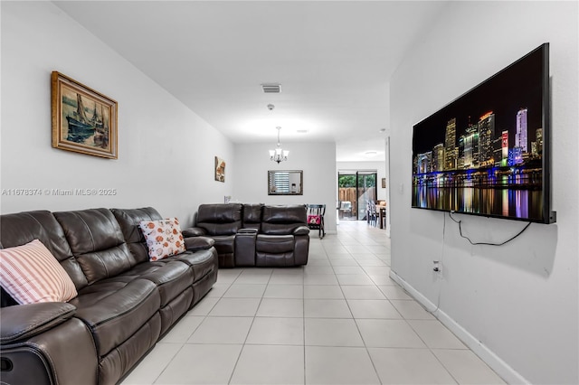 tiled living room featuring an inviting chandelier