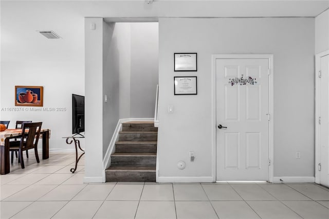 stairs featuring tile patterned floors