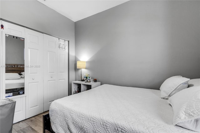 bedroom with light wood-type flooring and a closet