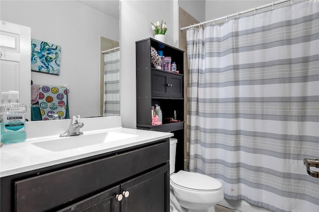 bathroom featuring vanity and toilet