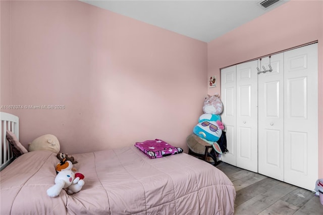 bedroom with a closet and wood-type flooring