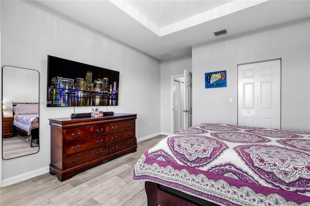 bedroom featuring light wood-type flooring and a closet