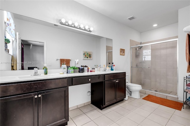 bathroom featuring tile patterned floors, vanity, and a shower with door