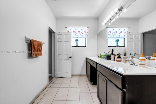 bathroom with tile patterned floors and vanity