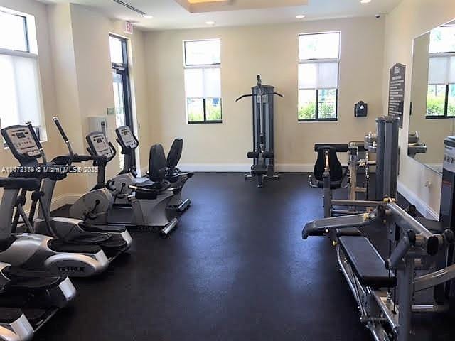 workout area featuring a raised ceiling