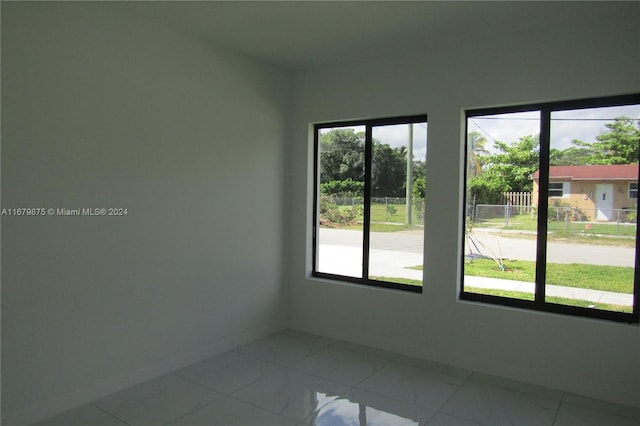 spare room with tile patterned flooring