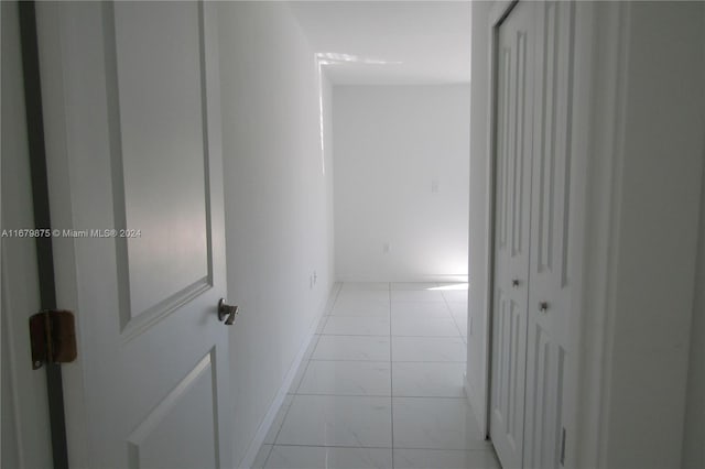 corridor with light tile patterned floors