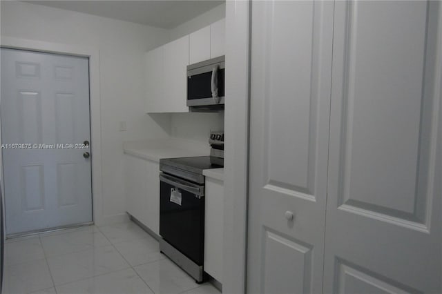 kitchen with white cabinetry and appliances with stainless steel finishes