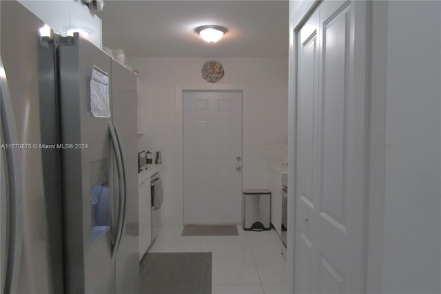 laundry area featuring independent washer and dryer and light tile patterned flooring