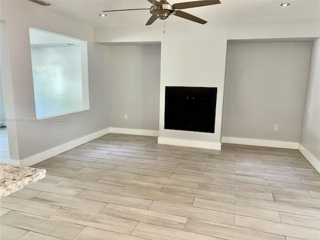 unfurnished living room featuring ceiling fan