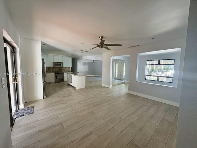 unfurnished living room featuring ceiling fan
