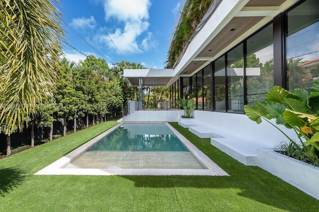 view of pool with a yard and a patio area