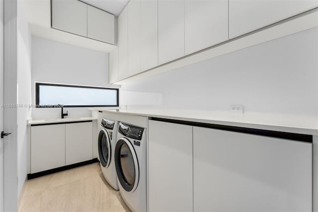 650 Warren Ln, Key Biscayne, FL 33149 - washroom featuring a sink, washer and dryer, and cabinet space