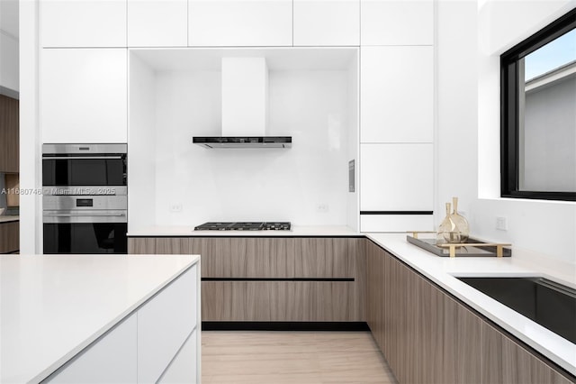 650 Warren Ln, Key Biscayne, FL 33149 - kitchen featuring light countertops, appliances with stainless steel finishes, modern cabinets, and extractor fan