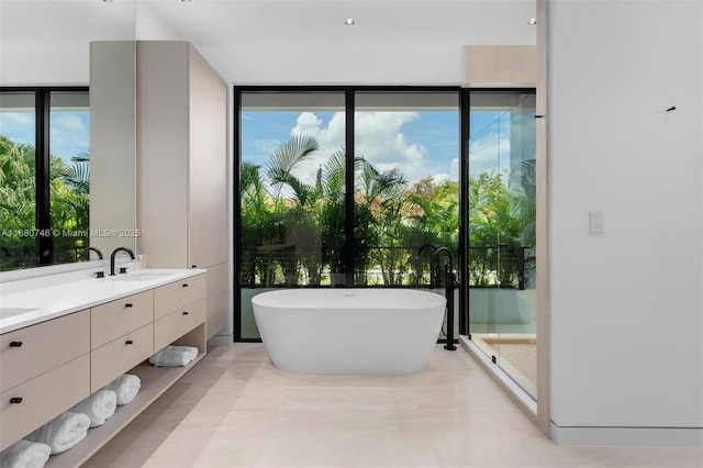 650 Warren Ln, Key Biscayne, FL 33149 - full bathroom featuring a sink, expansive windows, double vanity, and a freestanding bath