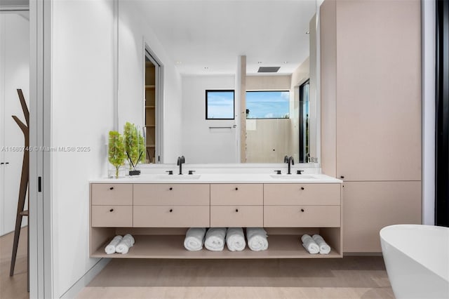 650 Warren Ln, Key Biscayne, FL 33149 - bathroom featuring double vanity, visible vents, a freestanding tub, and a sink
