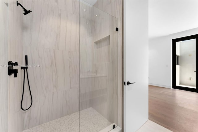 650 Warren Ln, Key Biscayne, FL 33149 - bathroom featuring a marble finish shower and wood finished floors