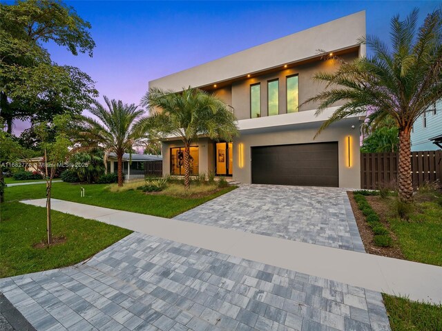 contemporary house with a yard and a garage