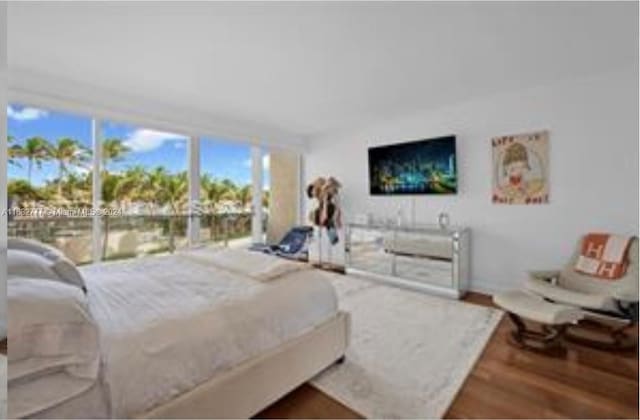 bedroom featuring hardwood / wood-style floors and access to exterior