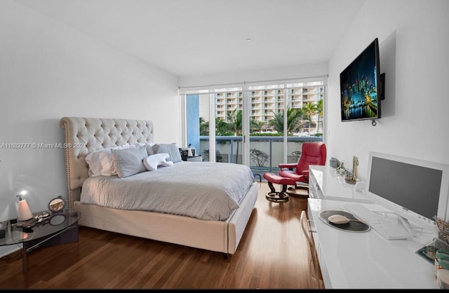 bedroom featuring wood-type flooring and access to outside