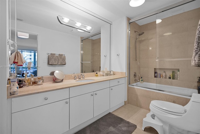 full bathroom featuring vanity, tiled shower / bath, toilet, and tile patterned floors