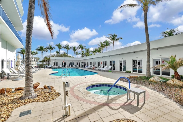 view of swimming pool with a patio and a community hot tub