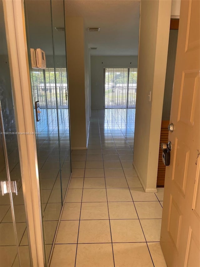 corridor with light tile patterned flooring