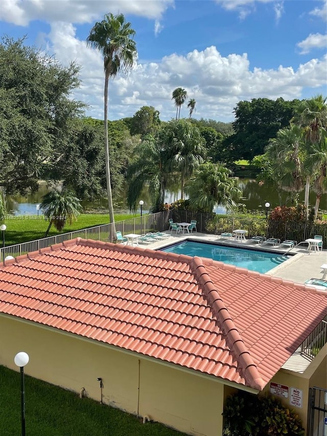 view of swimming pool featuring a water view