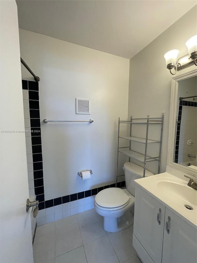 bathroom with toilet, a shower with curtain, vanity, and tile patterned flooring