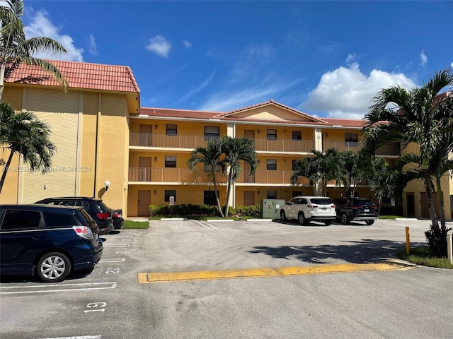 view of building exterior featuring uncovered parking