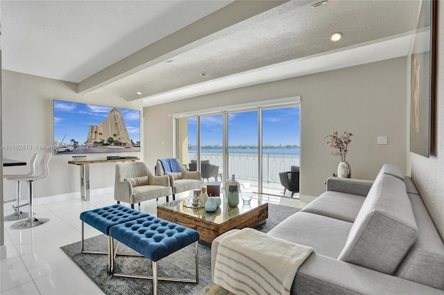 tiled living room featuring a textured ceiling and beamed ceiling