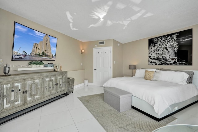 bedroom with light tile patterned floors