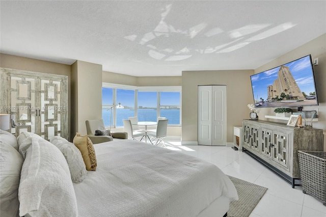 bedroom featuring a closet and light tile patterned floors