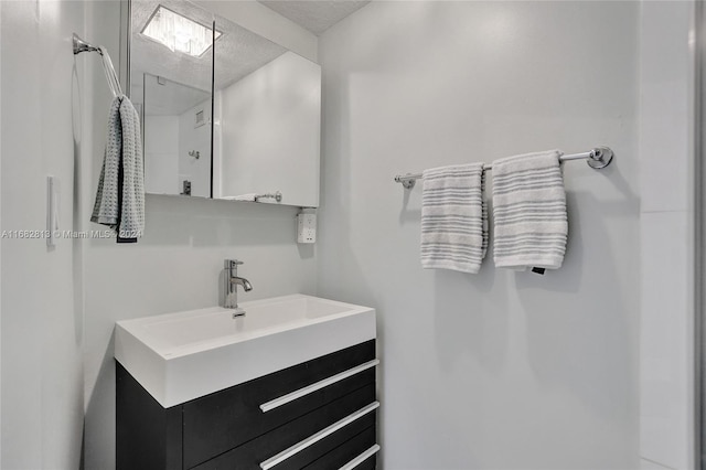 bathroom featuring vanity and a textured ceiling