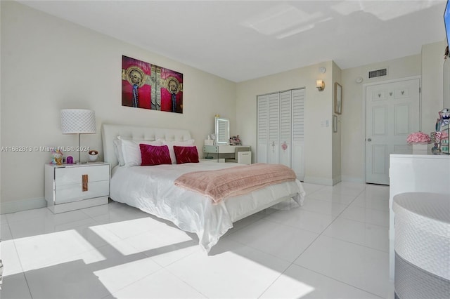 tiled bedroom with a closet