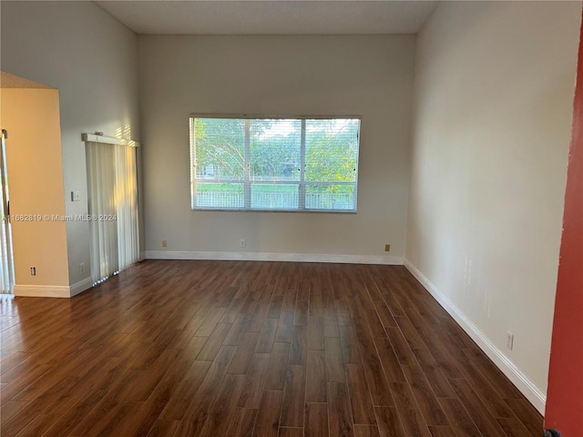 empty room with dark wood-type flooring