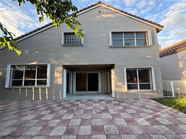 rear view of house featuring a patio