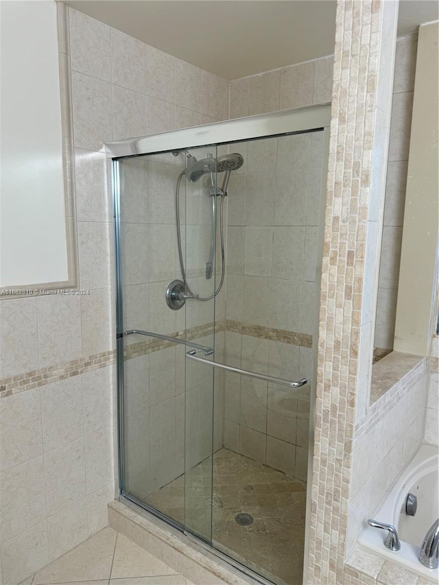 bathroom featuring tile patterned floors and plus walk in shower