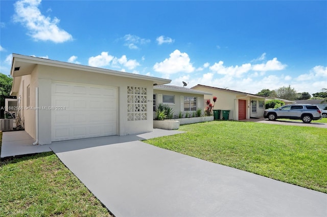 single story home with a front yard, a garage, and central AC unit