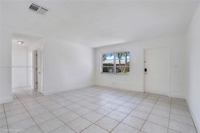 spare room with light tile patterned floors